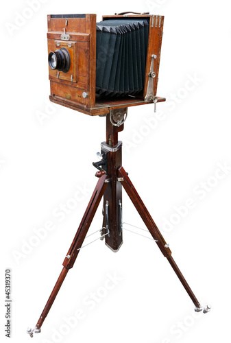 Wooden classic camera on tripod. Clipping path.