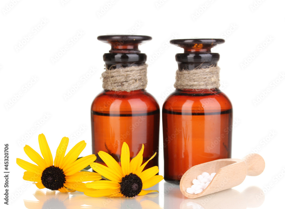 medicine bottles with tablets and flowers isolated on white medicine bottles with tablets and flowers isolated on white