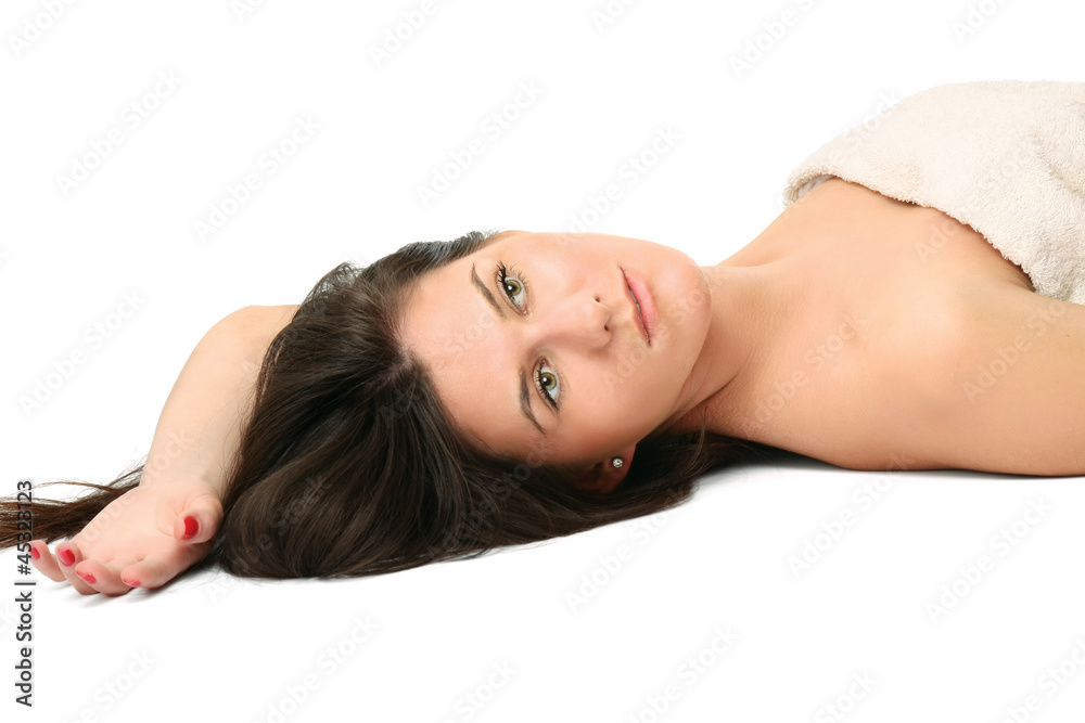 A beautiful young woman lying, isolated on white background A beautiful young woman lying, isolated on white background