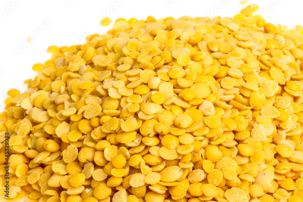 Yellow lentils isolated on white background. Macro shot