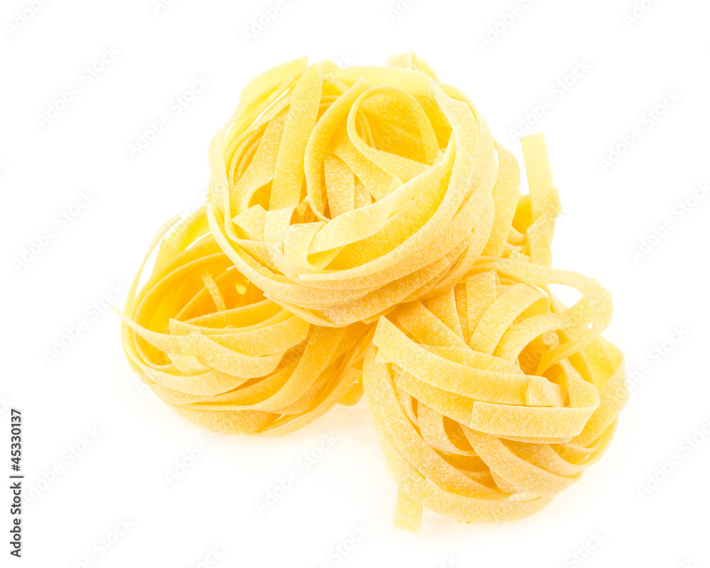 Italian pasta fettuccine nest isolated on white background Italian pasta fettuccine nest isolated on white background