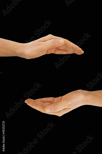 Hands making empty space, isolated on black background