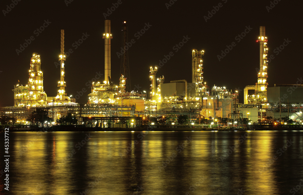 Oil refinery plant night scene nearby river in Thailand Oil refinery plant night scene nearby river in Thailand