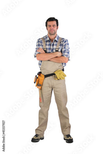 Serious laborer with arms crossed