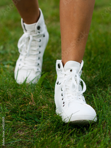 Legs of woman walking on grass