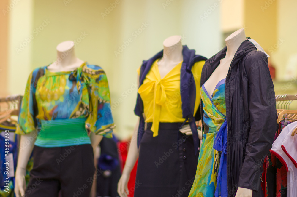 Color dresses and suits on mannequins in mall Color dresses and suits on mannequins in mall