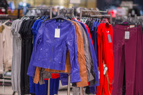 Color jackets, trousers on stands in mall