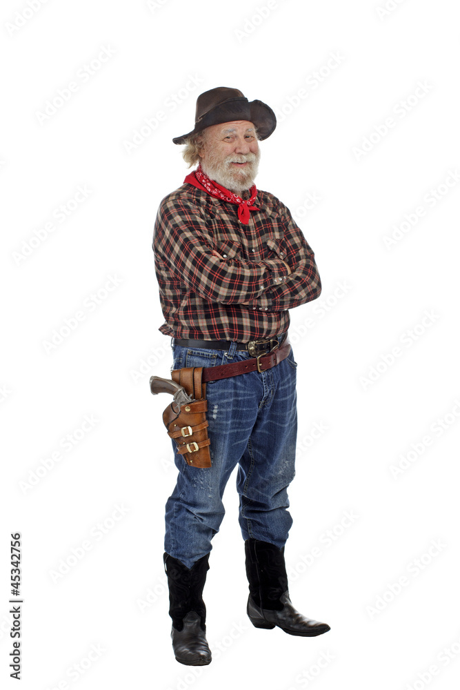 Smiling old cowboy stands with arms crossed Smiling old cowboy stands with arms crossed