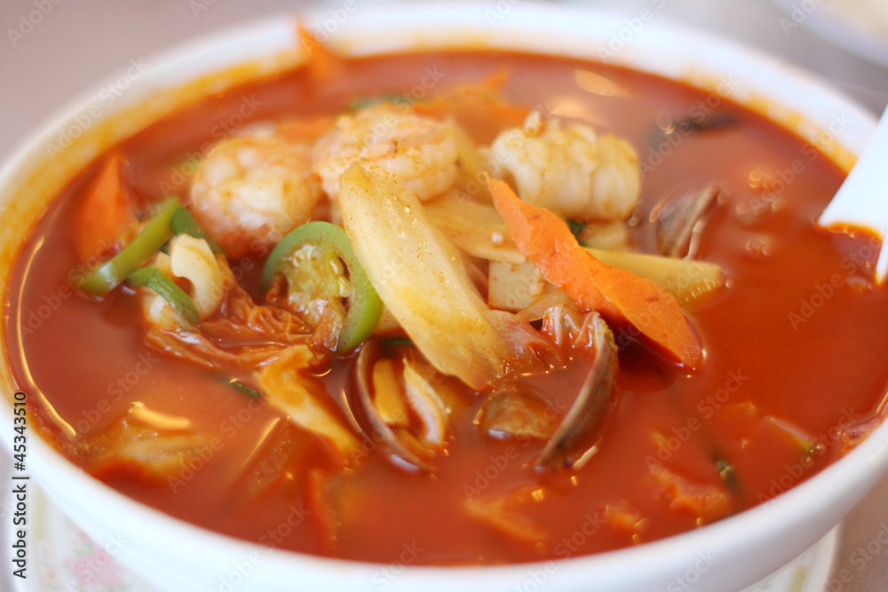 Bowl of spicy seafood soup at a Chinese restaurant. Bowl of spicy seafood soup at a Chinese restaurant.
