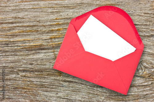 Red envelope on wooden background