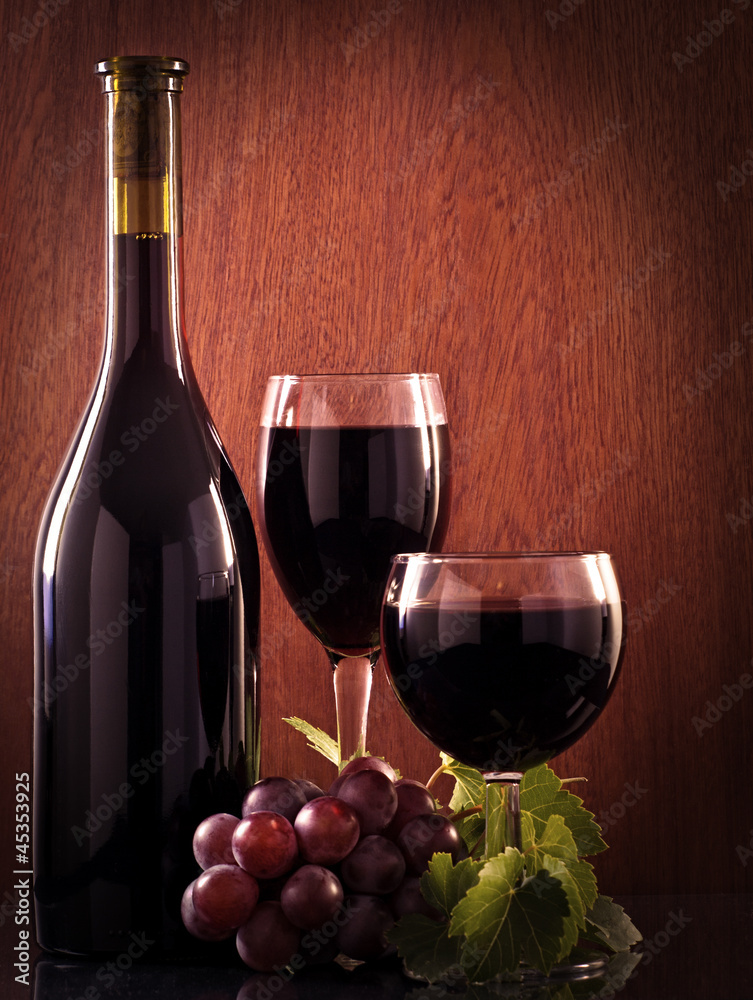 Red wine glass and Bottle on a wooden background