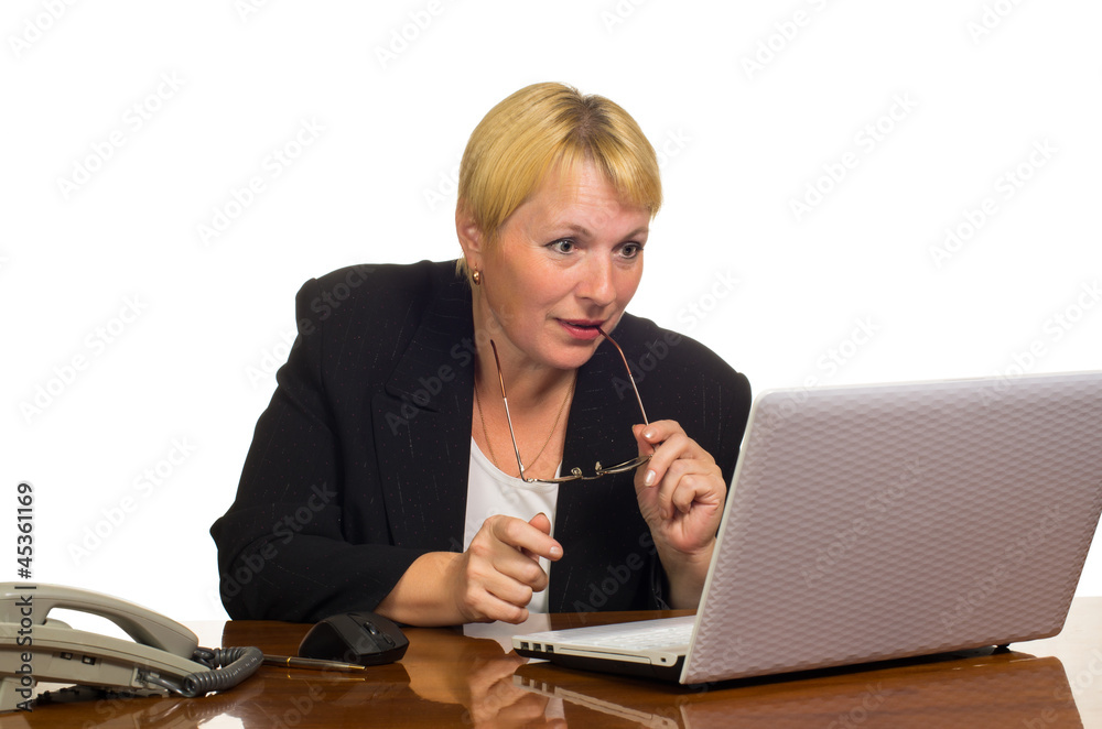Mature businesswoman looking at the laptop screen Mature businesswoman looking at the laptop screen