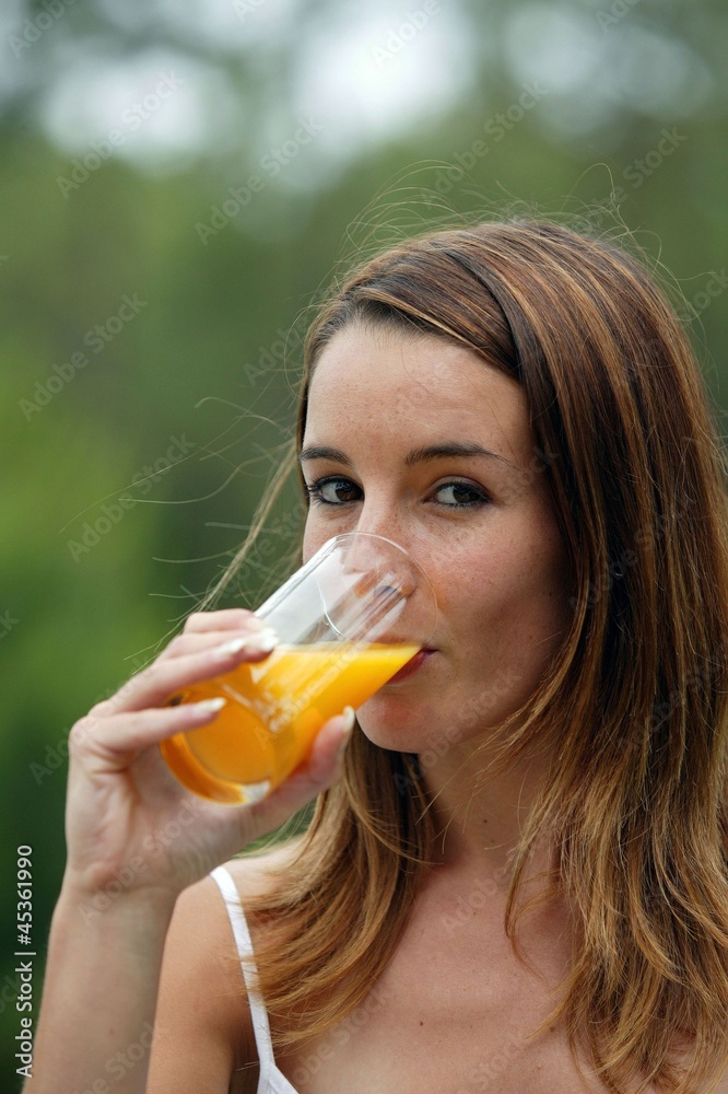 Woman drinking juice outdoors Woman drinking juice outdoors