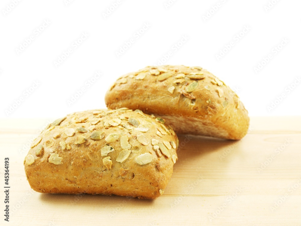 Bread with seeds isolated on a wooden board Bread with seeds isolated on a wooden board