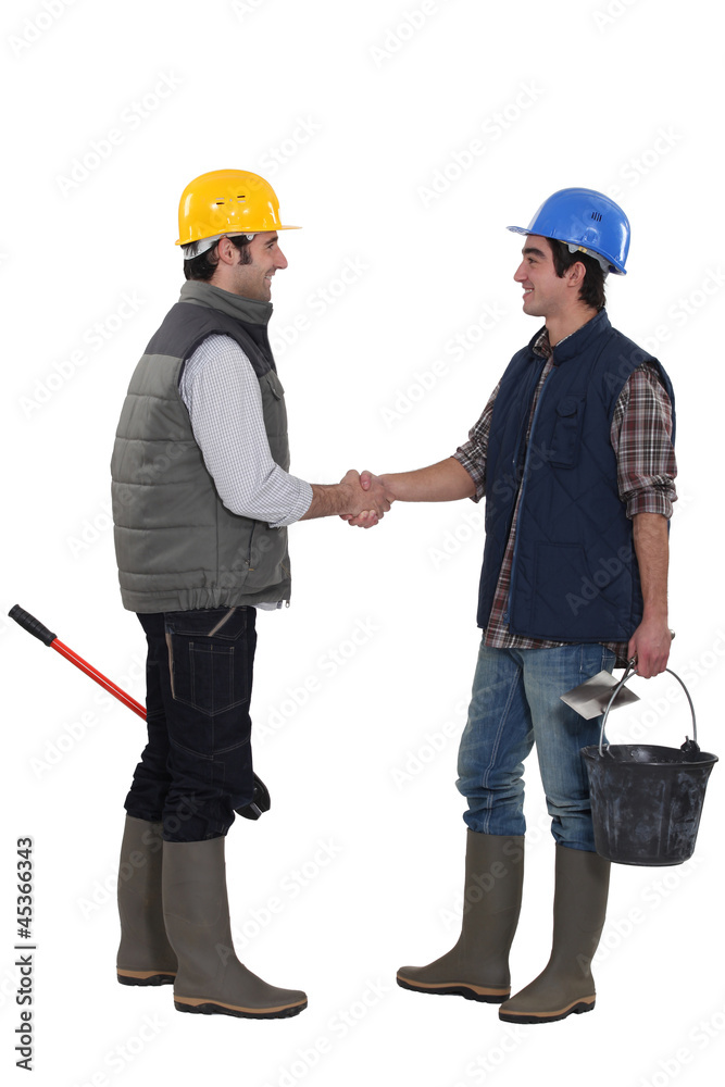 Construction workers shaking hands