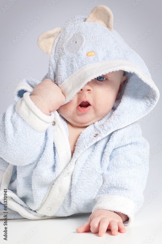 portrait of a cheerful child in blue bathrobe portrait of a cheerful child in blue bathrobe