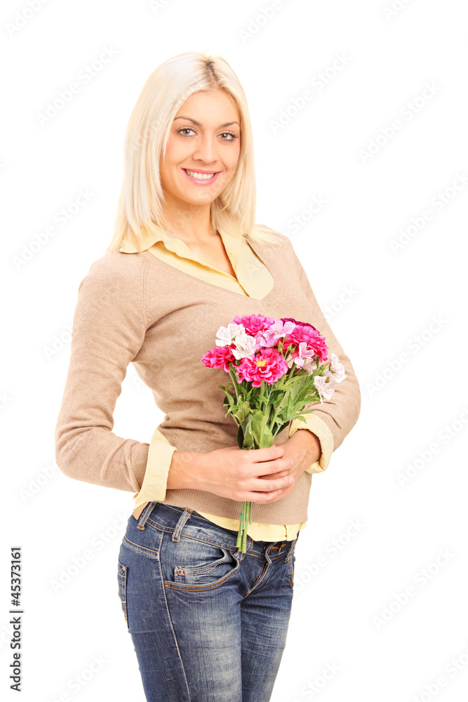 A smiling blond woman holding a bunch of flowers A smiling blond woman holding a bunch of flowers