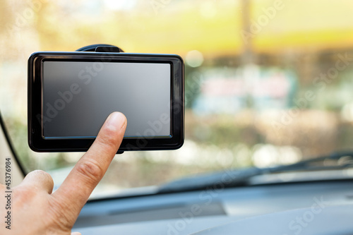 finger pointing at car GPS