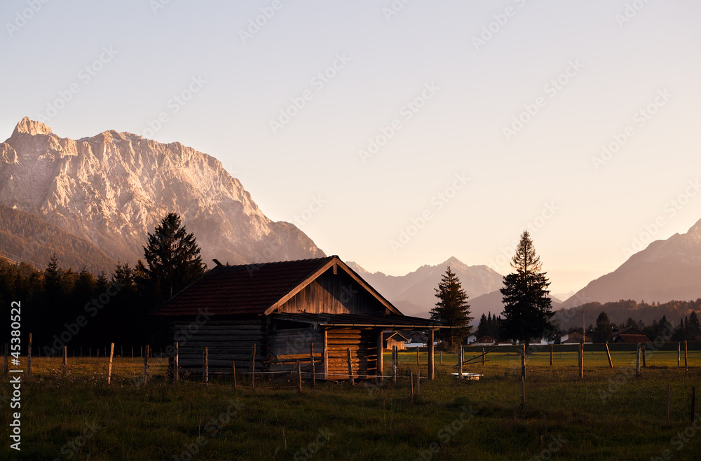 alpine wooden house before sunset