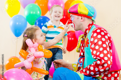 happy children and clown on birthday party photo