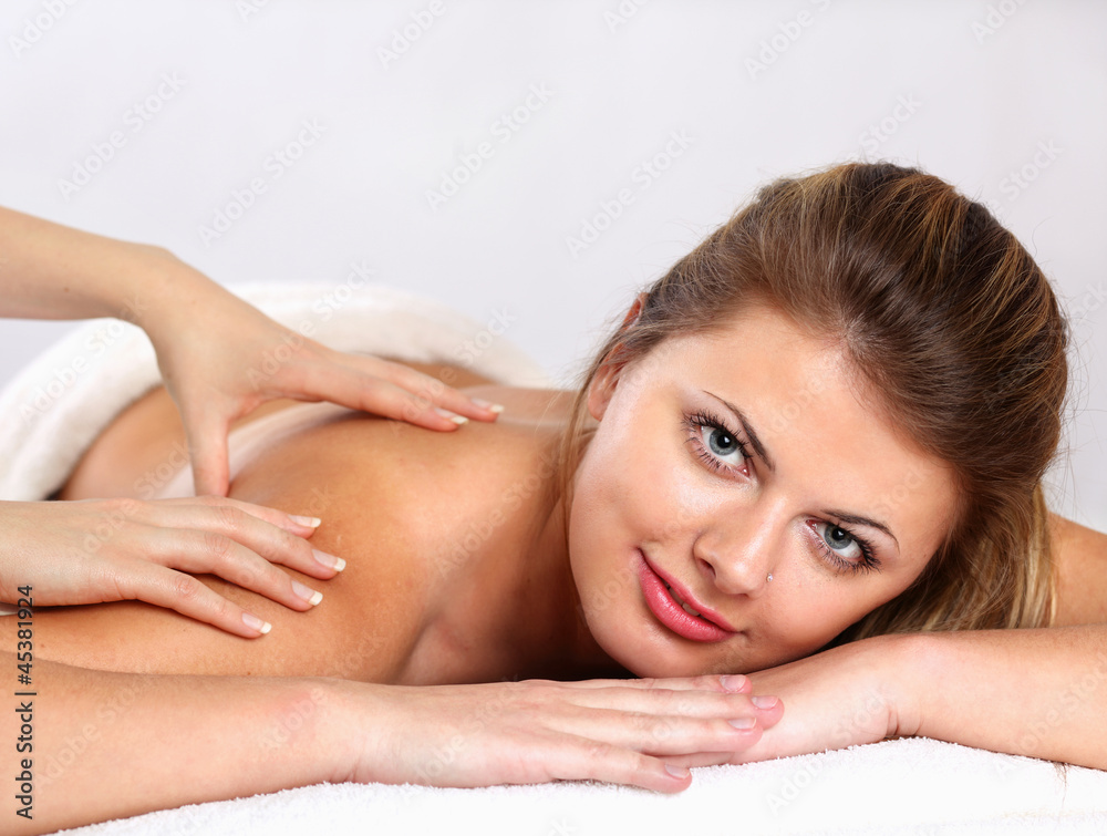 Closeup of an attractive young woman receiving massage Closeup of an attractive young woman receiving massage