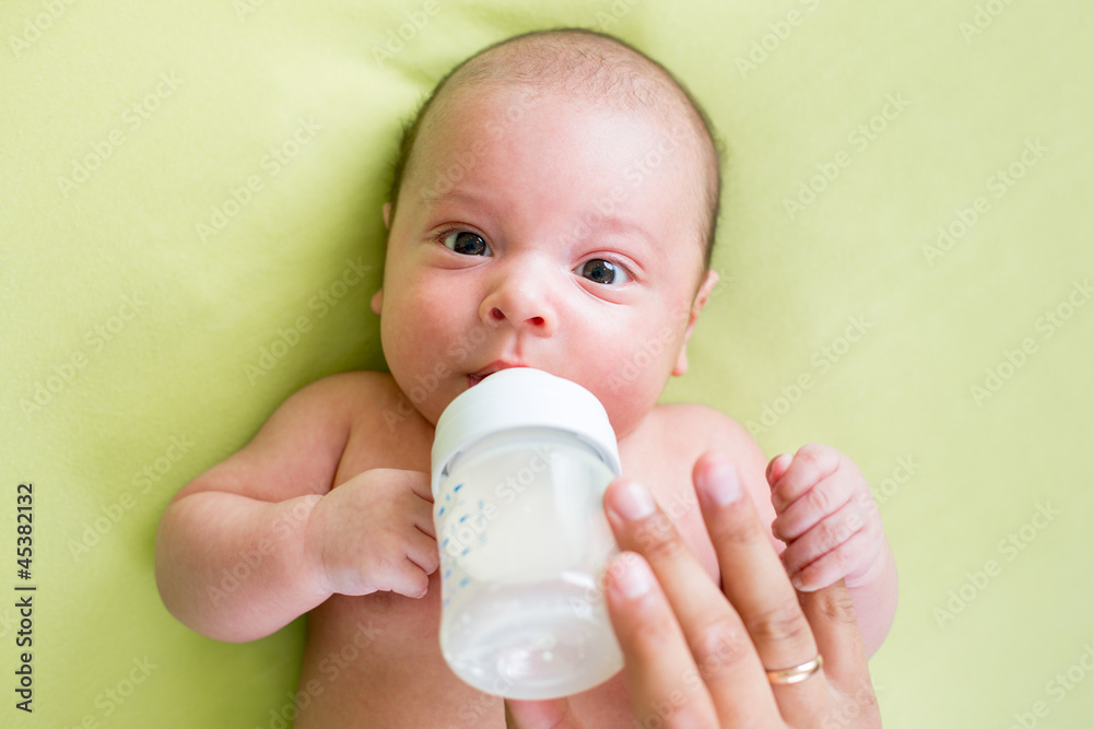 father feeding by milk his baby infant from bottle father feeding by milk his baby infant from bottle