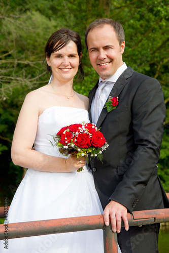 newly married couple with red roses