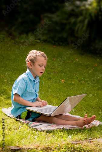 young boy using a laptop