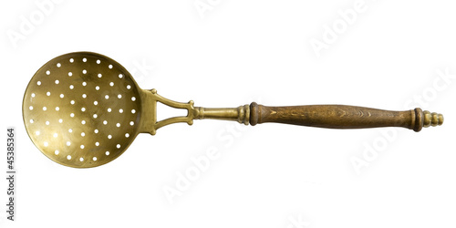 old brass sieve spoon on a white background photo