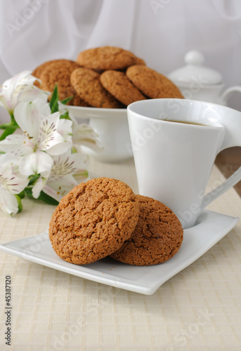 A cup of tea with oatmeal cookies