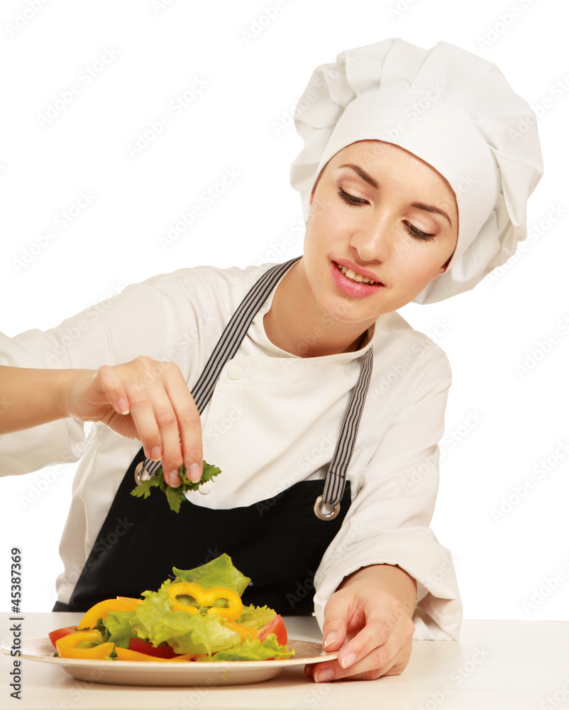 Portrait of a young cook in uniform preparing meal Portrait of a young cook in uniform preparing meal