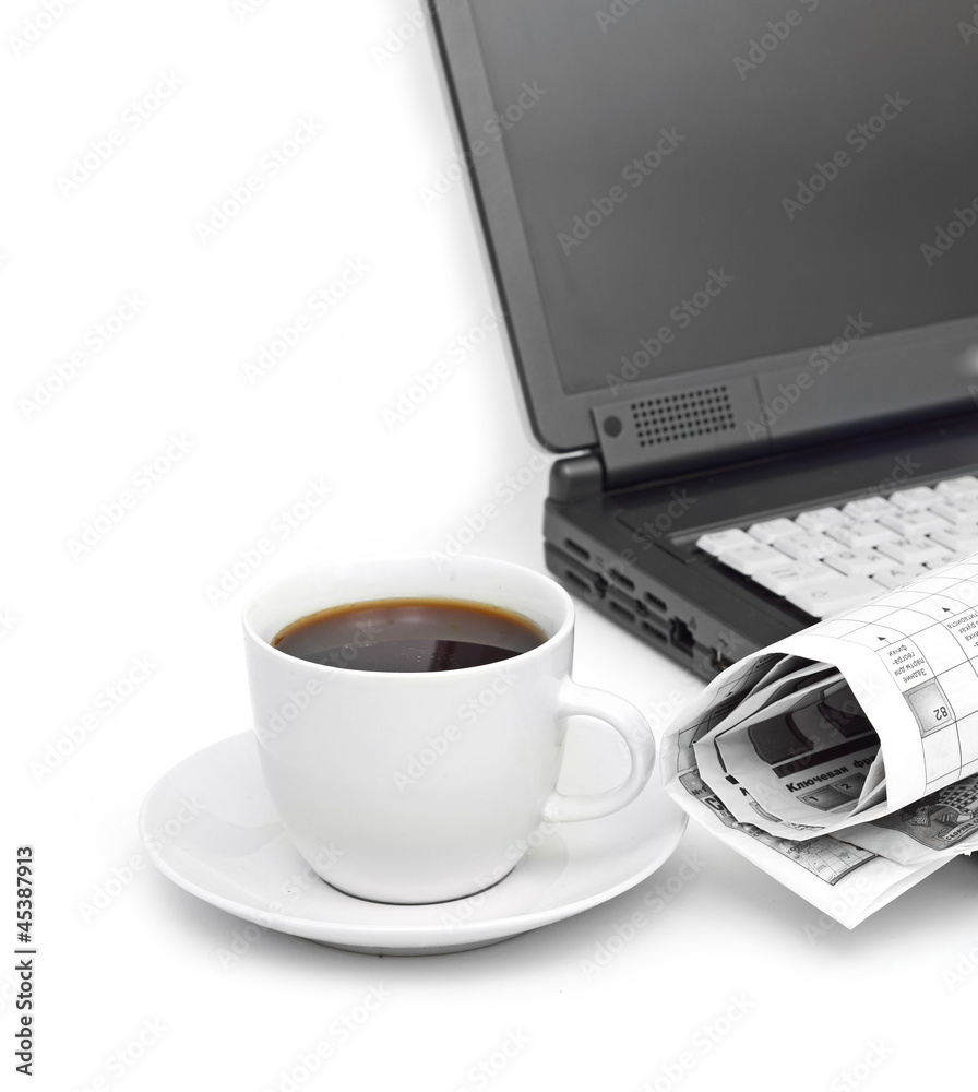 A cup of coffee on a laptop A cup of coffee on a laptop