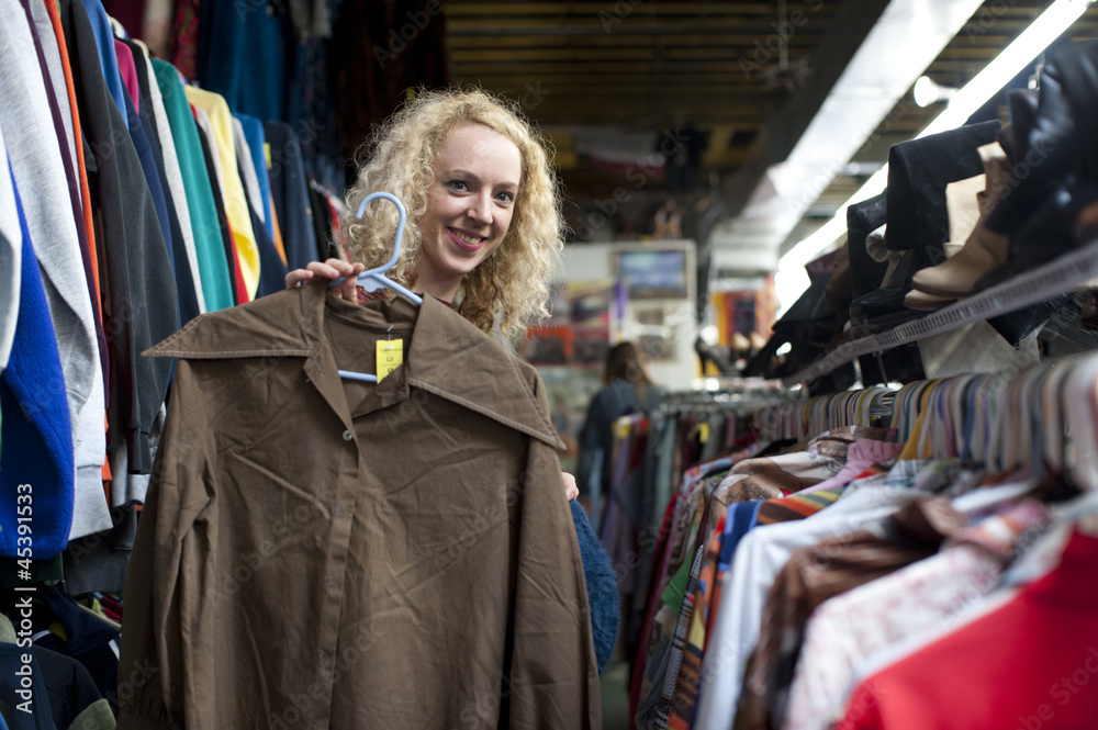 smiling girl with funny shirt at thrift store