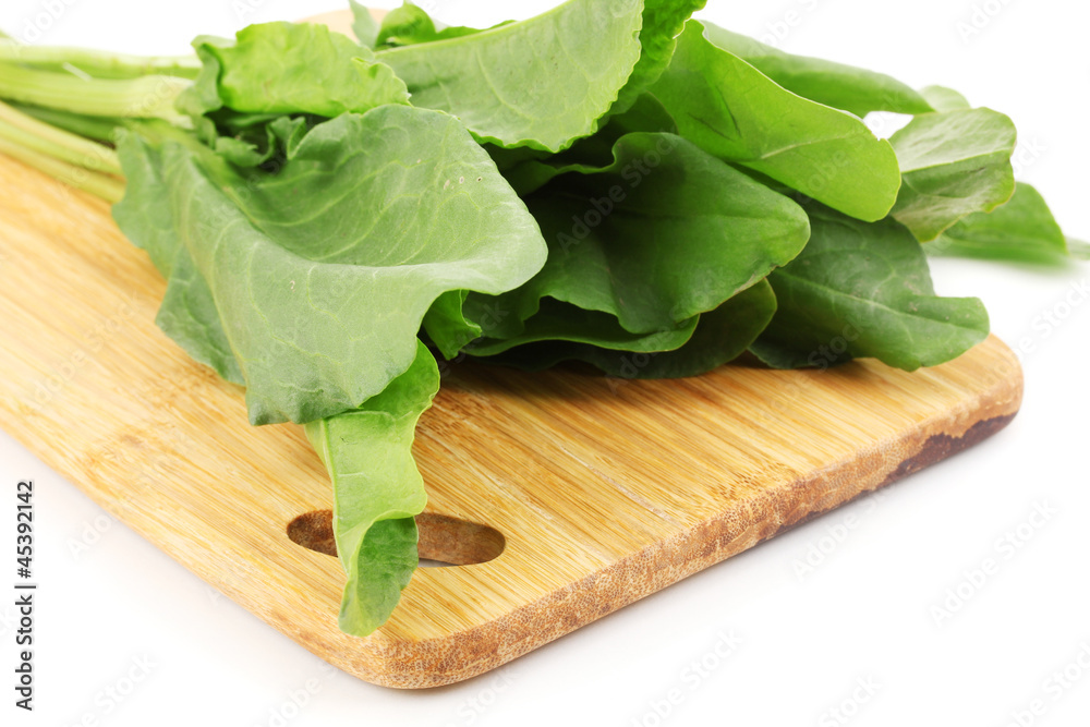 Fresh sorrel on wooden board isolated on white Fresh sorrel on wooden board isolated on white
