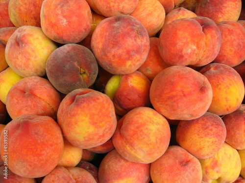 Many bright tasty peaches