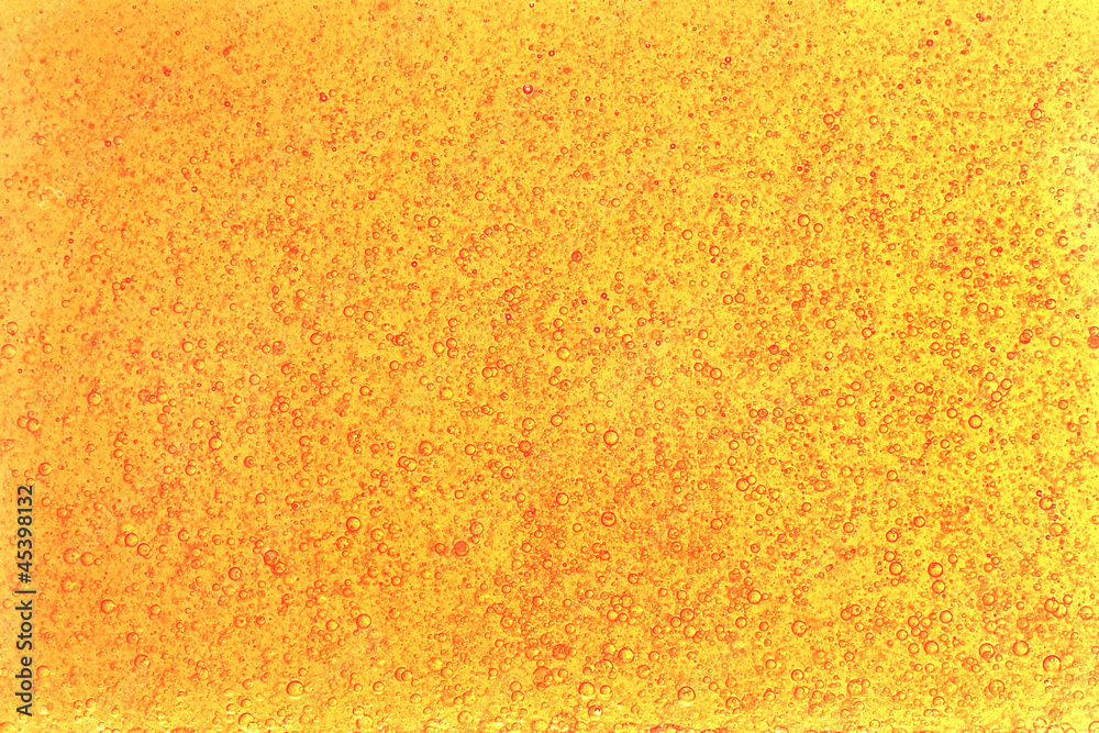 Fototapeta premium Background of yellow bubbles of oil in water.