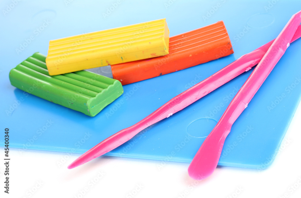 Fototapeta premium Children bright plasticine on desk with stacks isolated on