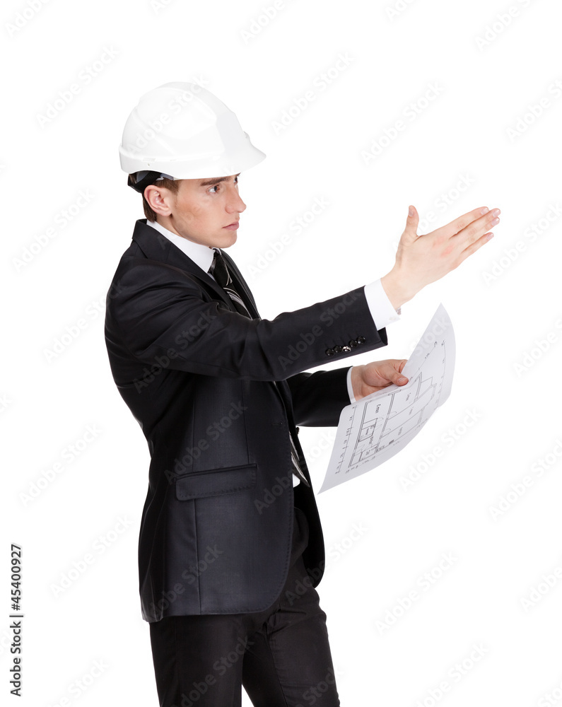 Businessman in white hard hat pointing at something Businessman in white hard hat pointing at something