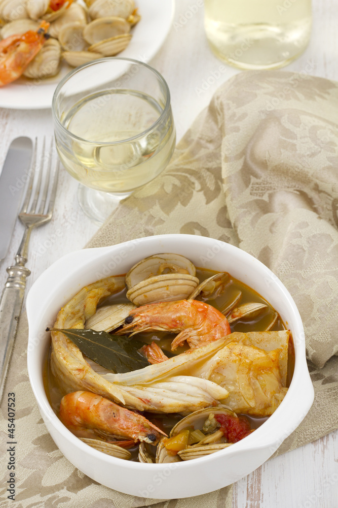 fish with seafood and vegetables in white bowl fish with seafood and vegetables in white bowl