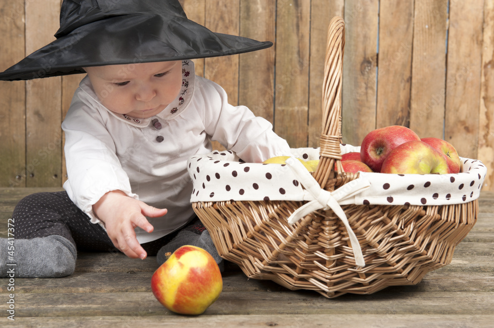 Fototapeta premium halloween baby with basket of apples