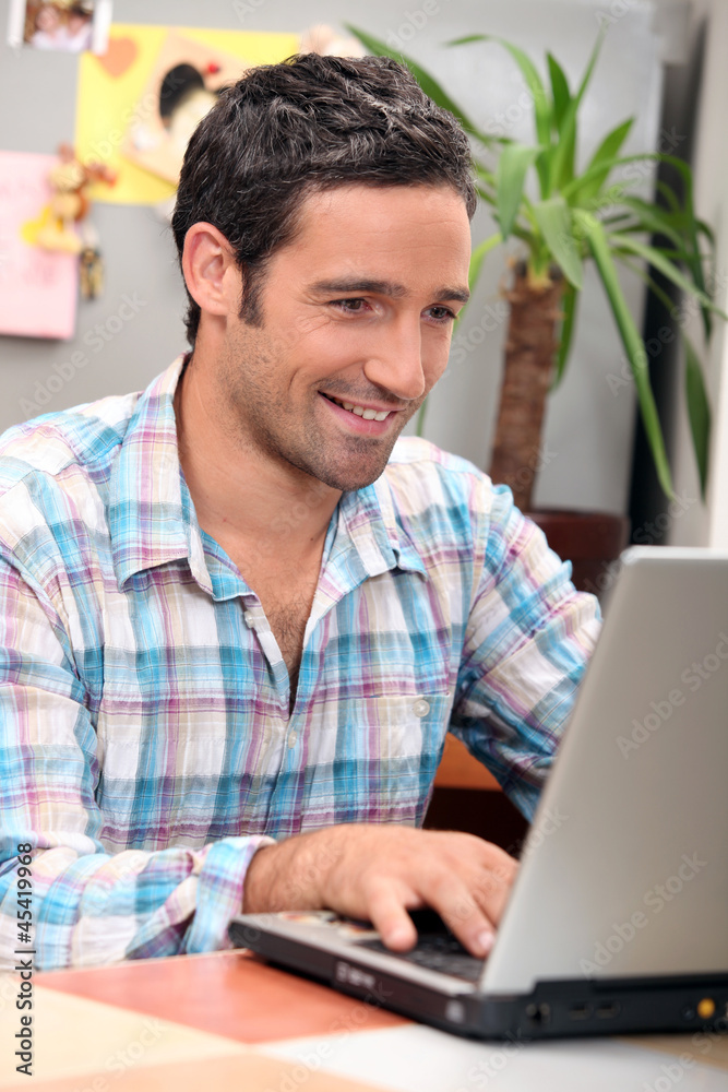 Man laughing in front of computer Man laughing in front of computer