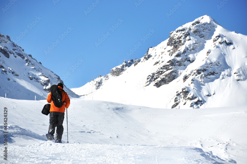 Hiking in snowshoes along the mountain track Hiking in snowshoes along the mountain track