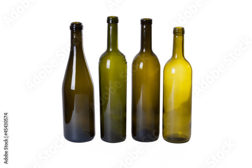 four dark empty wine bottles