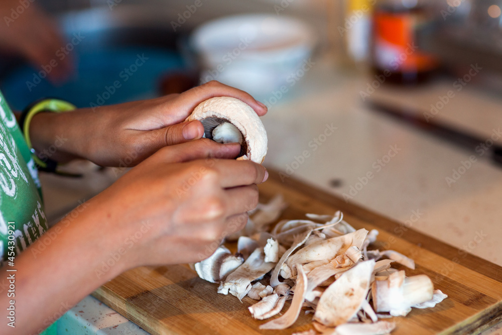 Kid peeling mushrooms