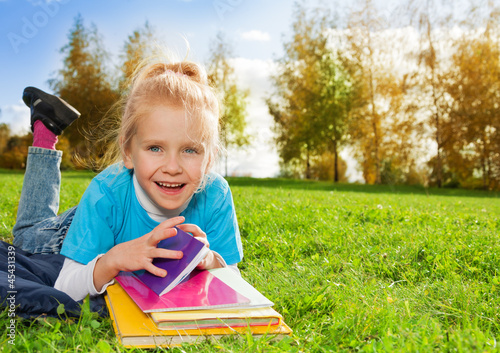 cute little girl with books in park © Sergey Novikov