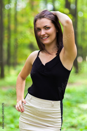 Young happy woman with hand on her hips