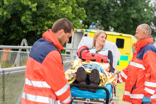 Injured woman talking with paramedics emergency