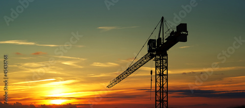 Construction crane on sunset
