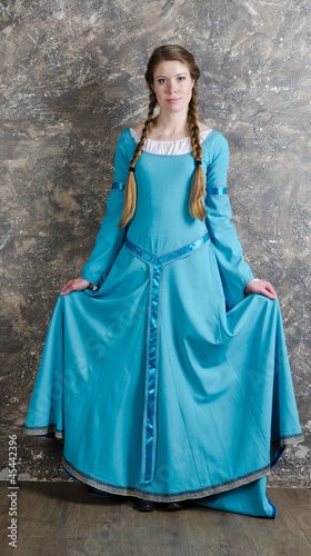 Portrait of the pretty young woman in blue dress