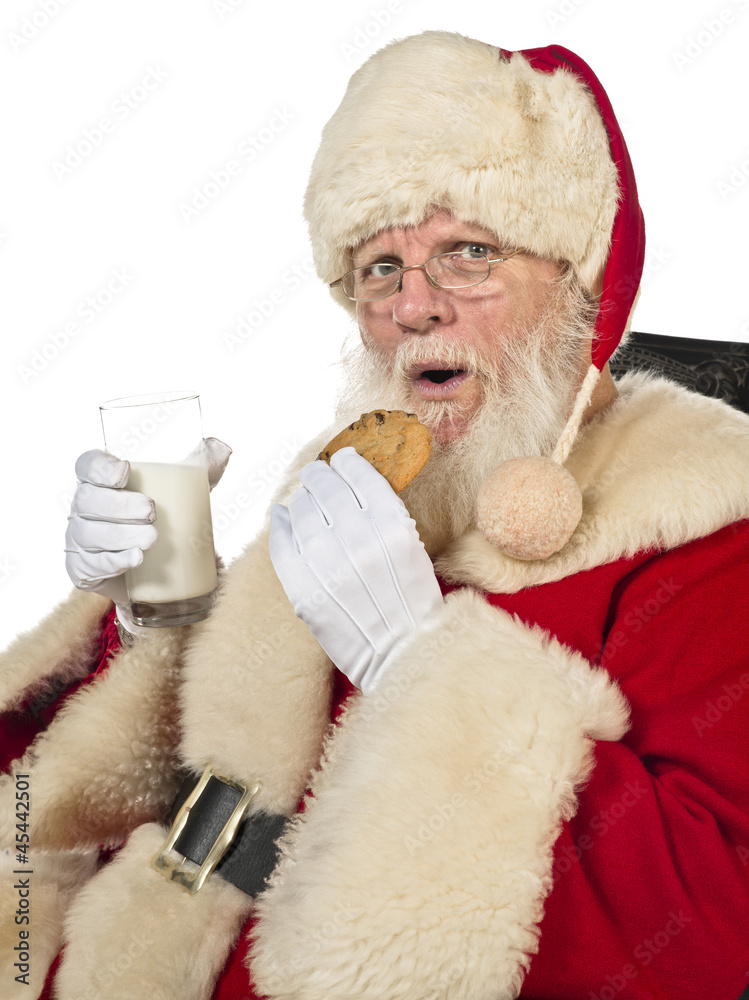 Obraz premium santa claus drinking milk and eating cookies